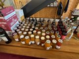 many jars of jams and bottles of wine on a table