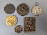 several medals and a medal on a table with a white background