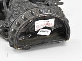 a black statue of a dragon with a tag on it