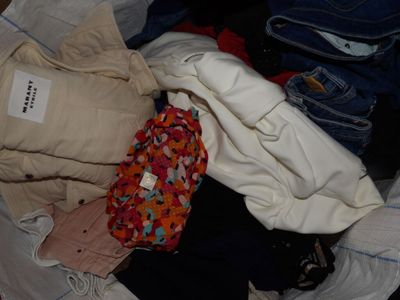 a pile of clothes that is sitting on the floor