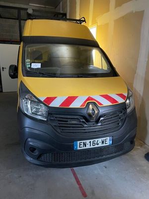 a yellow van with a red and white stripe parked in a garage
