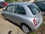 a silver car parked in a parking lot with other cars