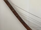 a wooden instrument that is on display in a room