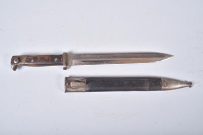 two knives that are laying on a white surface