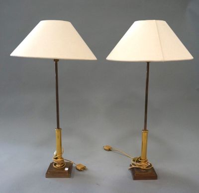 pair of brass and wood table lamps with white lampshads