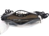 a black purse with a chain around it on a white surface