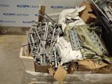 a pile of assorted metal items in a box