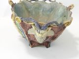 a small bowl with a bird on it on a white surface