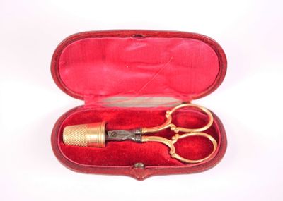 a red case with a pair of scissors inside of it