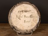 a white plate with writing on it sitting on a wooden table