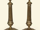 pair of antique brass candlesticks on a white background
