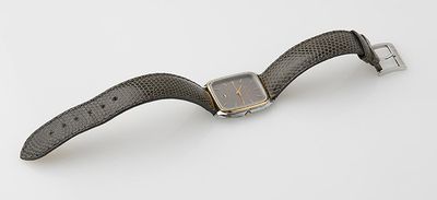 an image of a watch on a white surface with a black strap