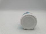 a white cup with a lid on a white surface
