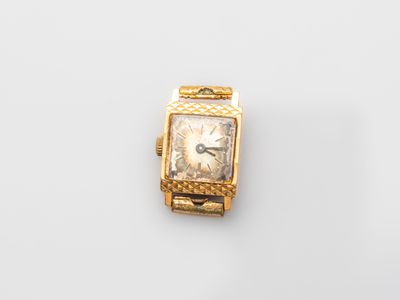 a close up of a watch on a white surface with a white background