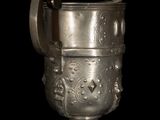 a silver cup with a handle on a black background