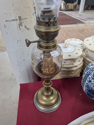 a lamp that is sitting on a table with plates on it