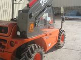 a picture of a forklift parked in front of a building