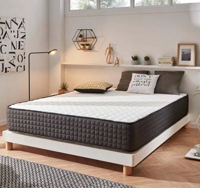 une photo d'une chambre à coucher avec un lit blanc et un tapis noir et blanc