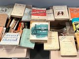 many books on the table and many of them are in the box