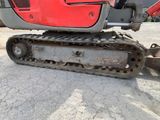 an image of a close up of a red and black excavator