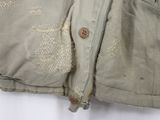a close up of a jacket with holes on it