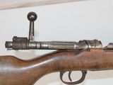 an old rifle with a wooden barrel and a metal handle