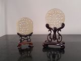 two small vases sitting on a table next to each other