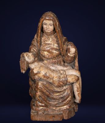 a statue of a woman holding a child on her lap
