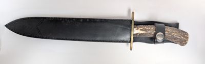 a knife that is laying on a white surface