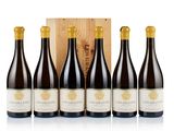 four bottles of wine in front of a wooden box