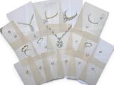 many pieces of jewelry on a white surface
