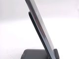 a cell phone sitting on a stand on a white surface
