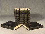 four books are stacked on top of each other on a table
