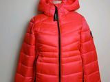 a woman ' s red down jacket on a mannequin mannequin mannequin mannequin mannequin mannequin mannequin manne