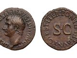 a close up of two old coins with a woman ' s face on them