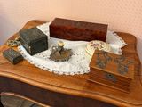 a small wooden box on a table with a lace doily around it