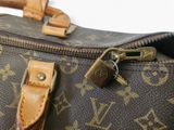 a close up of a louis vuitton bag with a lock on it