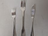four forks and a knife sitting on a table