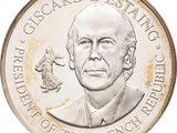 silver coin with a portrait of a man and a woman on it