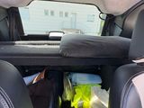 the back seat of a car with a bunch of items in it