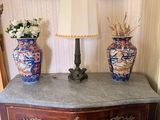 two vases sitting on top of a dresser next to a mirror