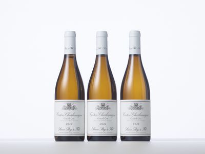 three bottles of white wine sitting on top of a table