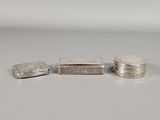 three silver objects sitting on top of a table next to each other