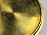 a close up view of a gold plated pocket watch