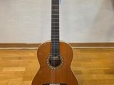 a guitar that is sitting on a stand on the floor