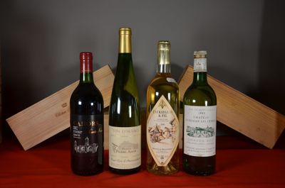 several bottles of wine are lined up on a red table