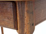 a close up of a wooden table with a drawer on it