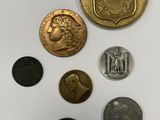 a close up of a group of coins on a white surface