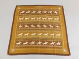 a brown and white scarf with horses on it