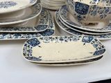 many plates and bowls on the table with blue and white designs